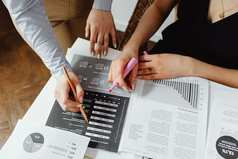 Business professionals collaborating on financial data analysis in a modern office setting.